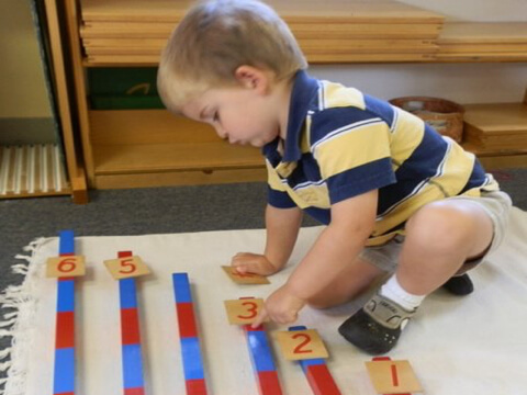 Boy working with number rods